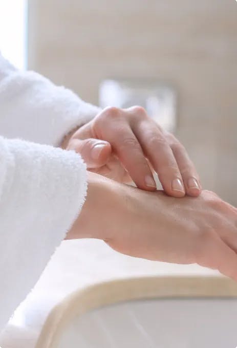 Woman Testing Cream On Her Hand